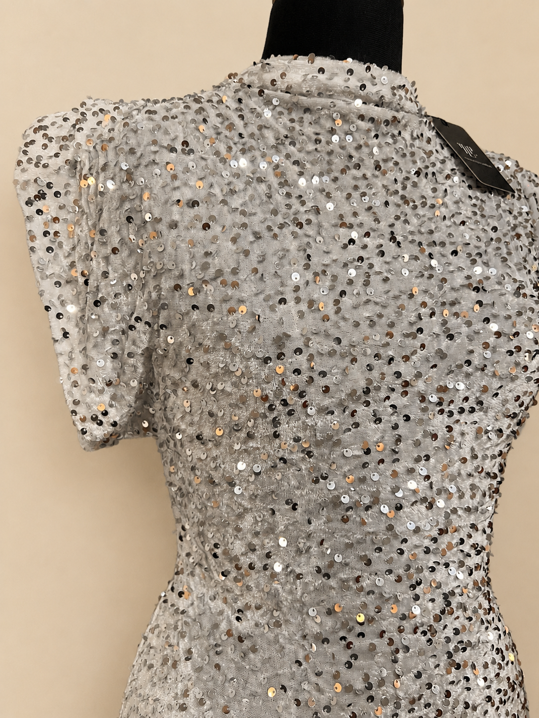 Crystal-white sequin mini dress, back view with short sleeves and neckline tag